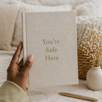 Hand holding journal front cover